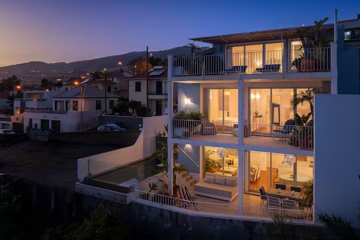 SeaHouse illuminated at dusk above Funchal and the Atlantic